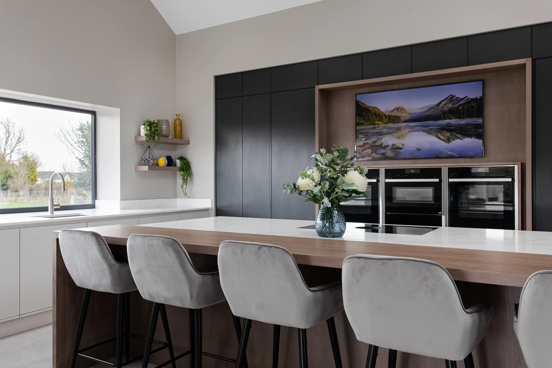 Contemporary Handleless Island with Calacatta Quartz and Tall Black Bank Units Dorans