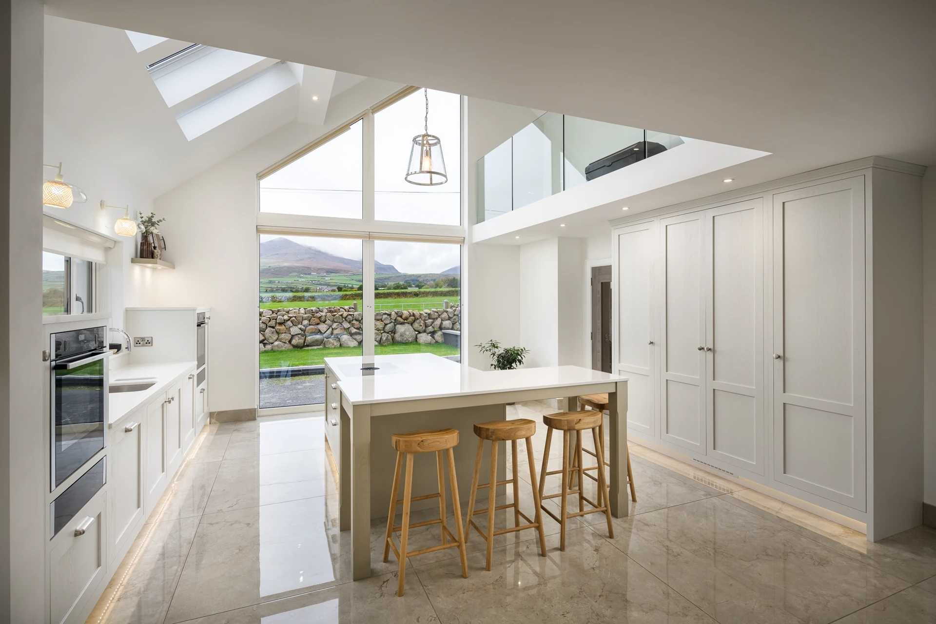 Farrow & Ball Strong White Kitchen with Countryside Views and Island Seating Doran Kitchens