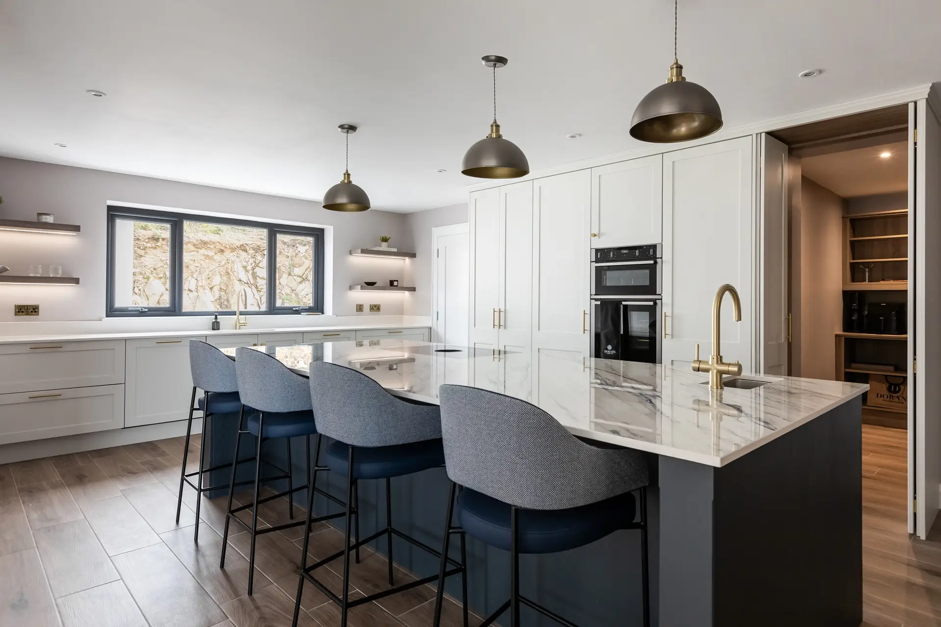 Bespoke Kitchen in Strong White with Feature Breakfast Station, Brass Handles, and Dekton Trance Worktop Doran Kitchens