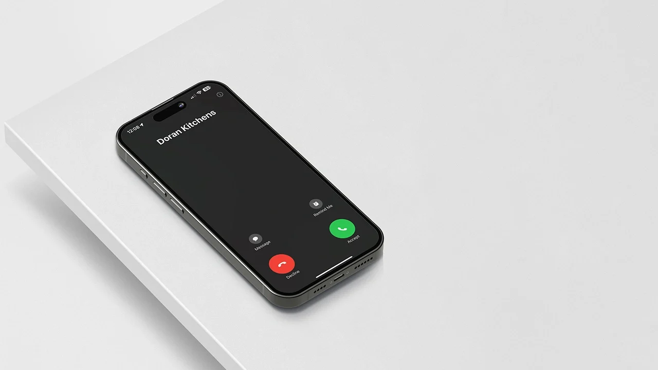 iPhone on Light Grey Counter Top with Incoming Call from Doran Kitchens